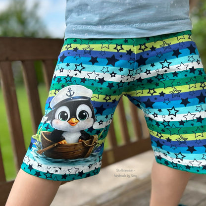 Bügelbild schwarzer Pinguin im Boot