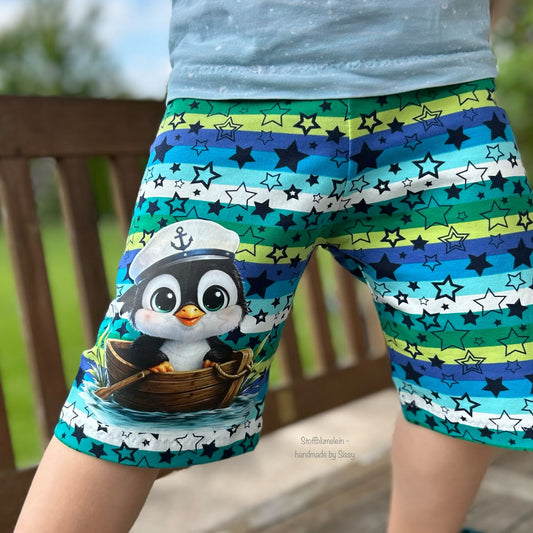 Bügelbild schwarzer Pinguin im Boot